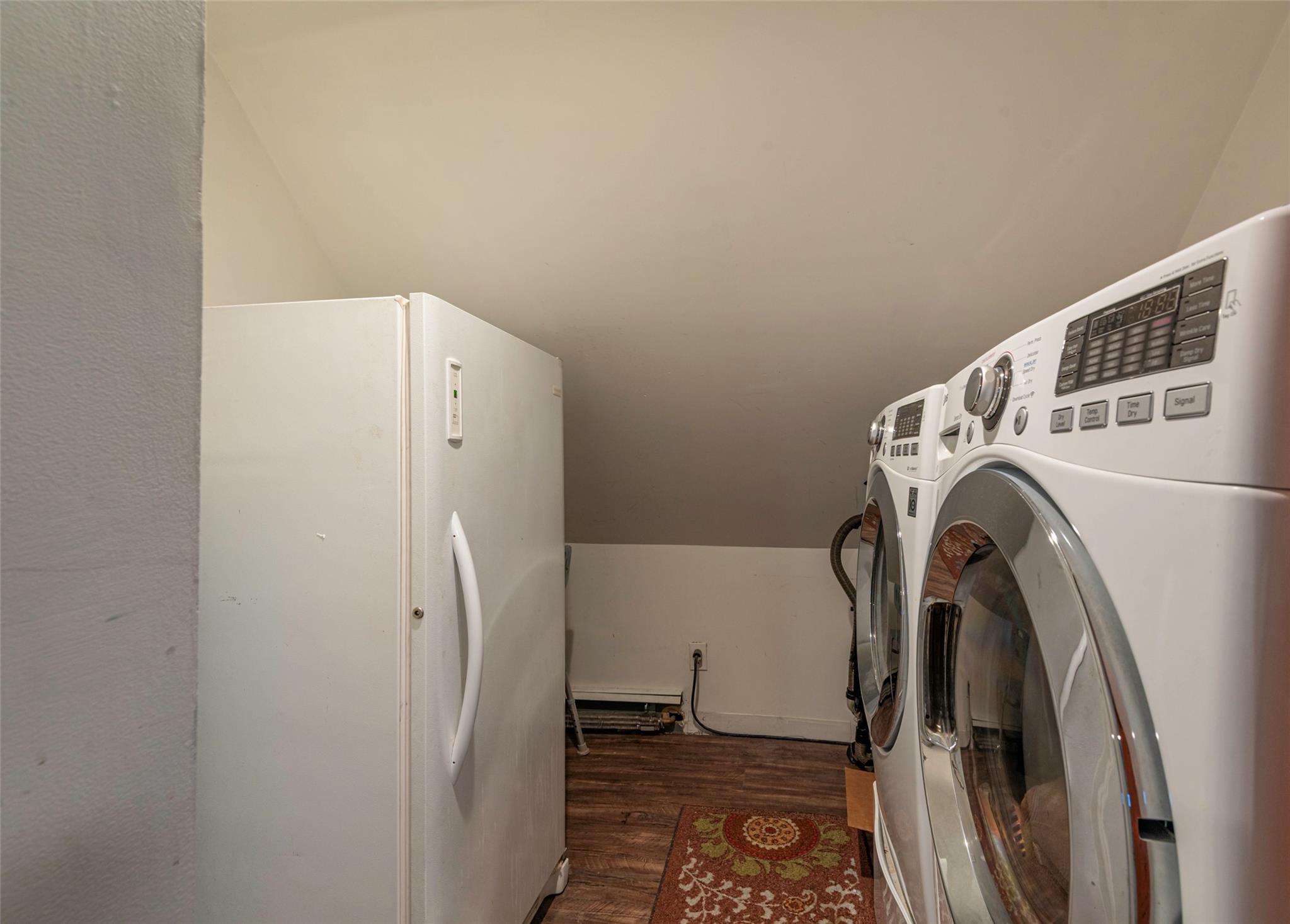 22 Lowland Road Levittown, NY 11756 - Photo 23 of 38 Washroom featuring separate washer and dryer and wood finished floors
