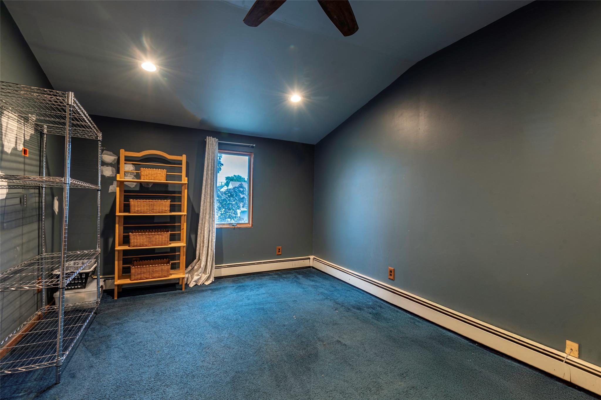 22 Lowland Road Levittown, NY 11756 - Photo 24 of 38 Unfurnished bedroom with baseboard heating, carpet, vaulted ceiling, recessed lighting, and ceiling fan