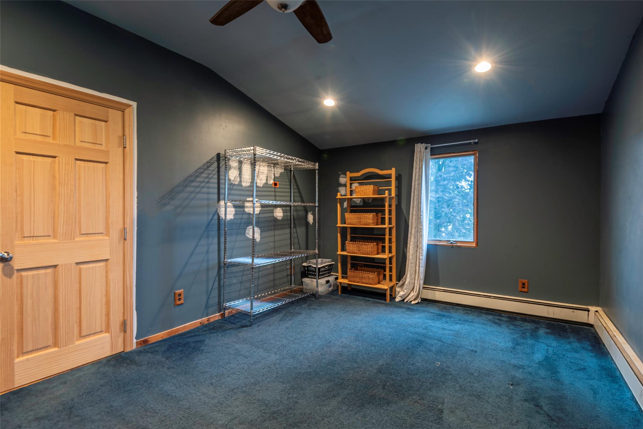22 Lowland Road Levittown, NY 11756 - Photo 25 of 38 Carpeted empty room with vaulted ceiling, a baseboard radiator, ceiling fan, and recessed lighting