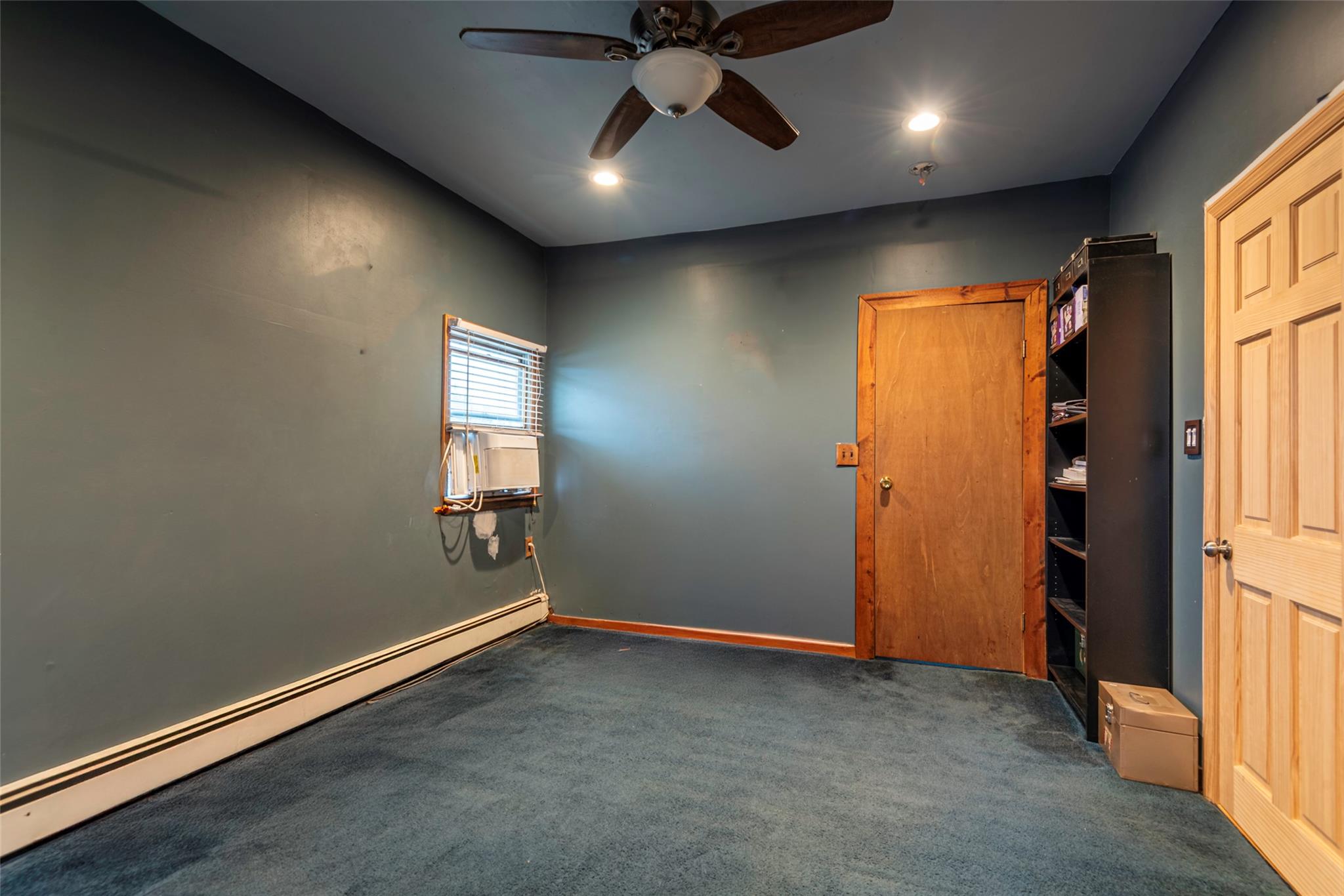 22 Lowland Road Levittown, NY 11756 - Photo 26 of 38 Carpeted empty room with a baseboard radiator, a ceiling fan, and recessed lighting