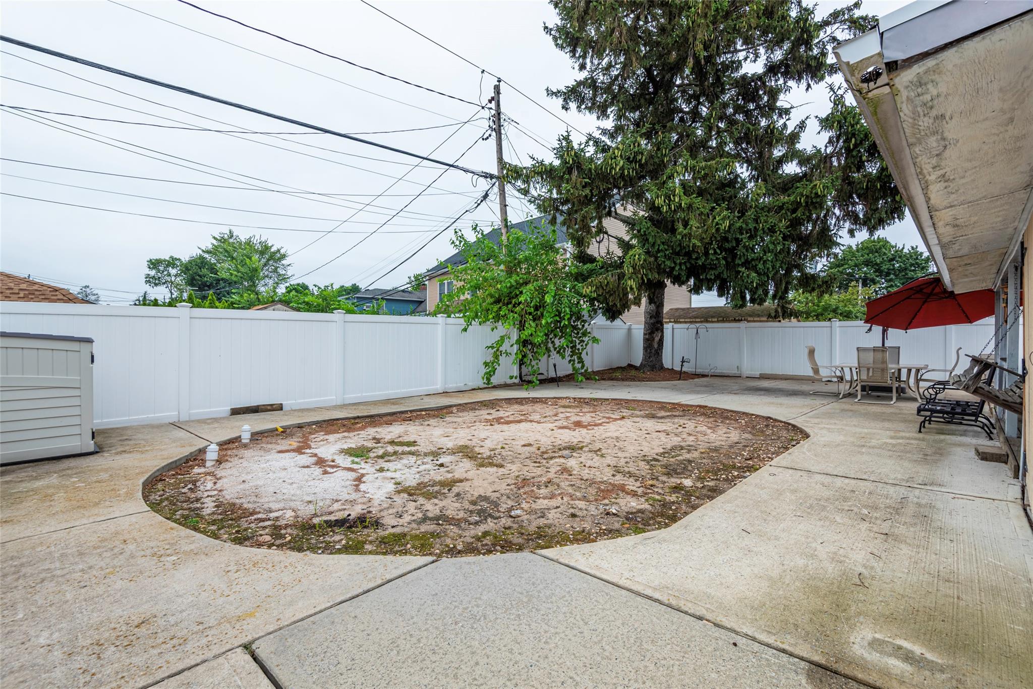 22 Lowland Road Levittown, NY 11756 - Photo 34 of 38 Fenced backyard with a patio area
