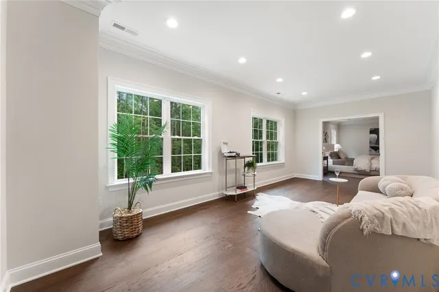 a view of a white house with a yard and plants