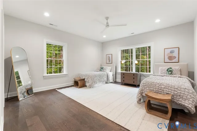 a view of a lush green field with lots of bushes