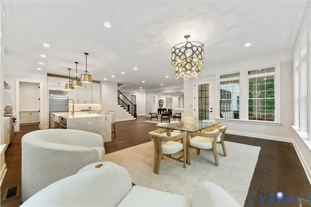 a living room with furniture a table and a chandelier