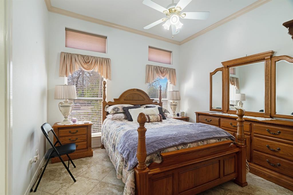 283 Butternut Lane Powderly, TX 75473 - Photo 19 of 32 a bedroom with a bed window and dresser
