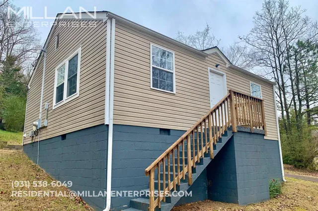 a front view of a house with wooden stairs