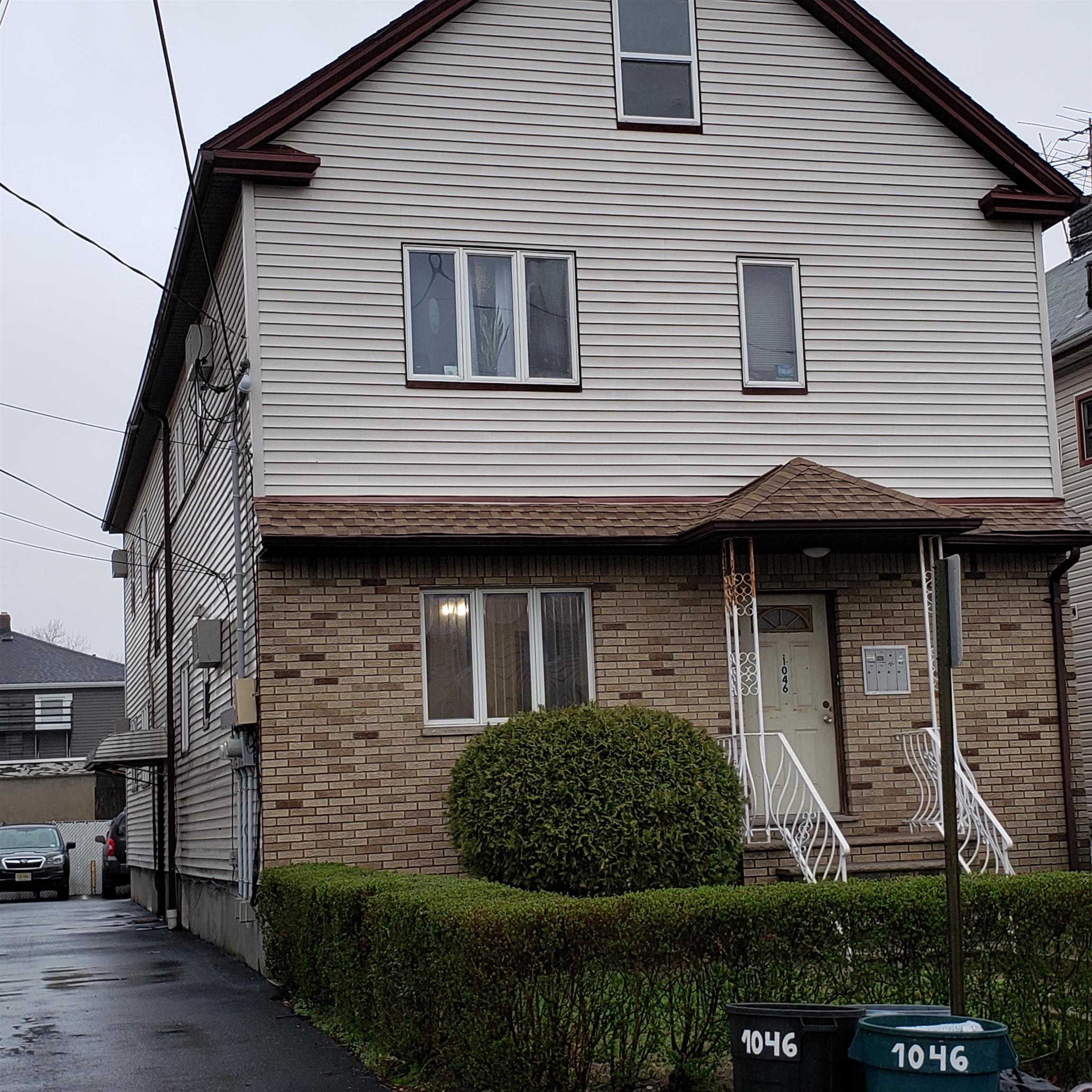 1046 Kilsyth Road Elizabeth, NJ 07208 - Photo 1 of 1 a front view of a house with a garden