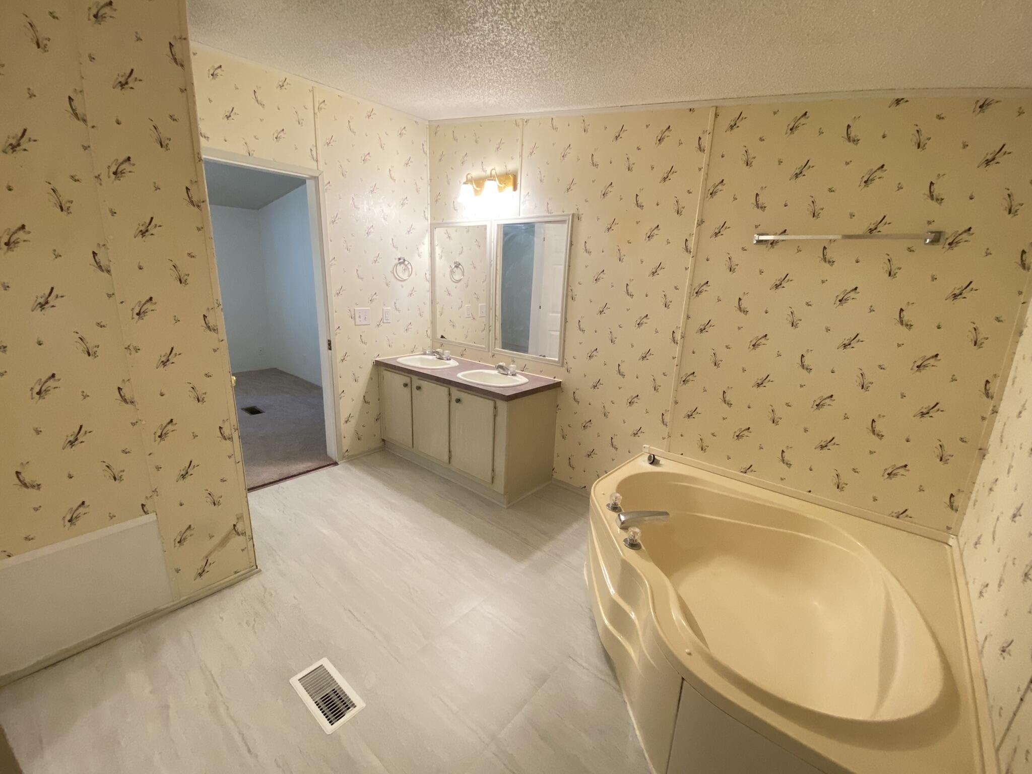 759 Briar Ridge Road Henry, VA 24102 - Photo 13 of 26 a bathroom with a bathtub sink and mirror