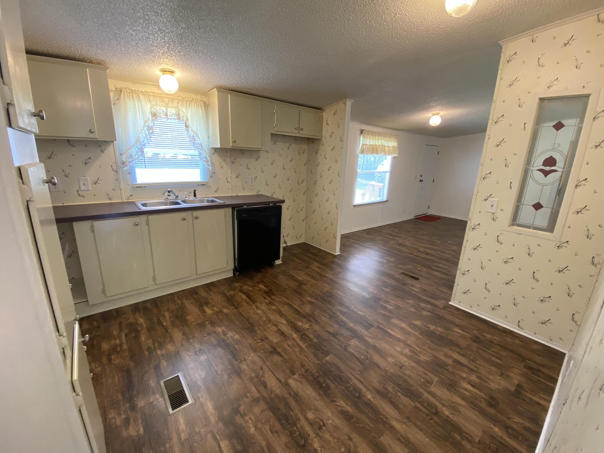 759 Briar Ridge Road Henry, VA 24102 - Photo 7 of 26 a kitchen with granite countertop a sink a window and stainless steel appliances