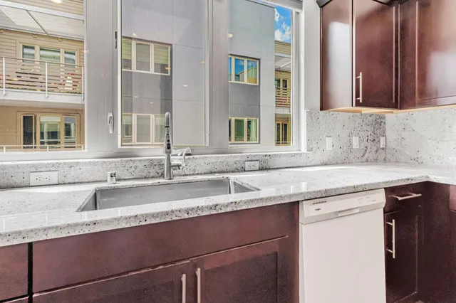a kitchen with granite countertop a sink and a window