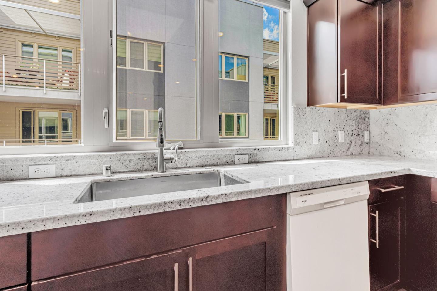 380 Riesling Avenue, Unit 21 Milpitas, CA 95035 - Photo 13 of 37 a kitchen with granite countertop a sink and a window
