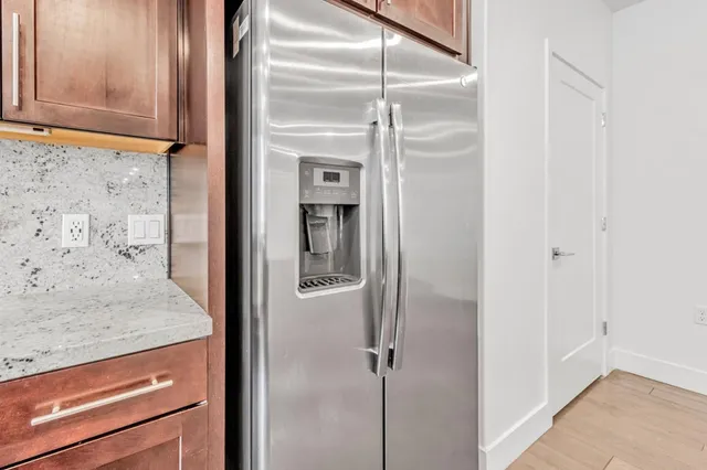 a bathroom with a granite countertop window and a shower