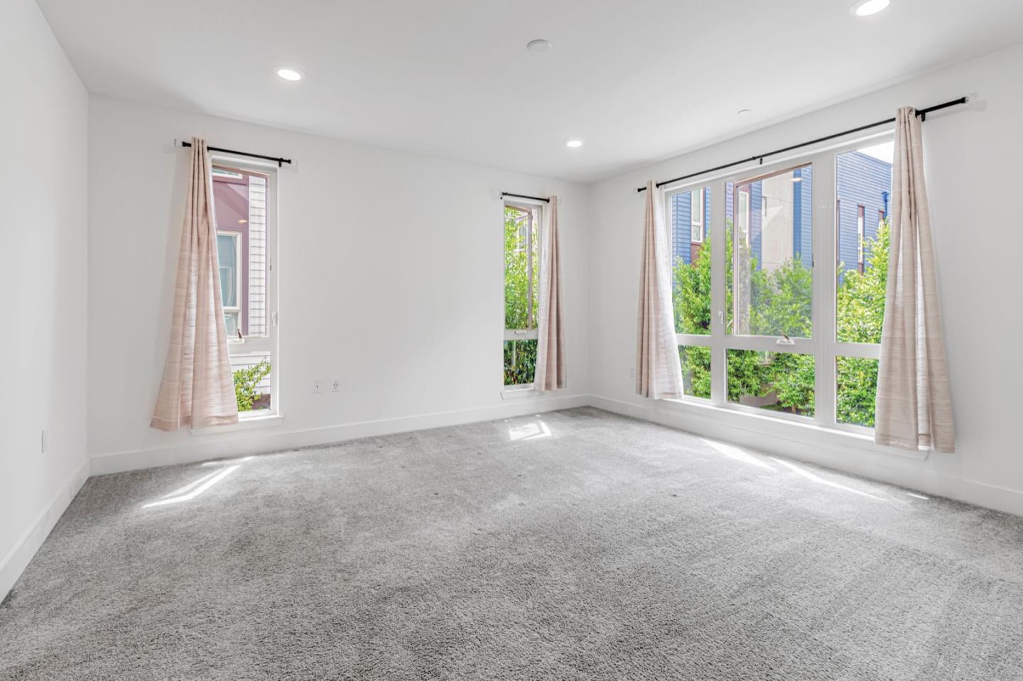 380 Riesling Avenue, Unit 21 Milpitas, CA 95035 - Photo 19 of 37 a view of a big room with windows and chandelier fan