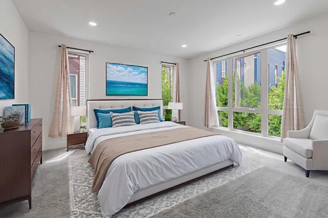 a bedroom with a large bed and a large window