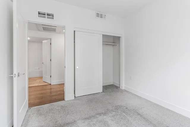 an empty room with closet area