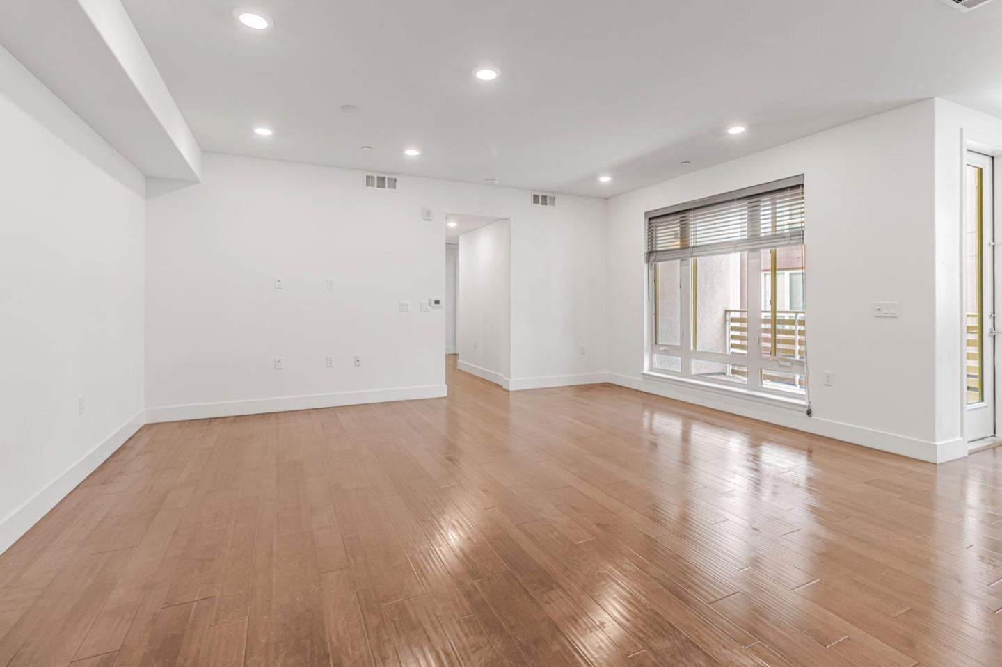 380 Riesling Avenue, Unit 21 Milpitas, CA 95035 - Photo 4 of 37 a view of an empty room with wooden floor and a window