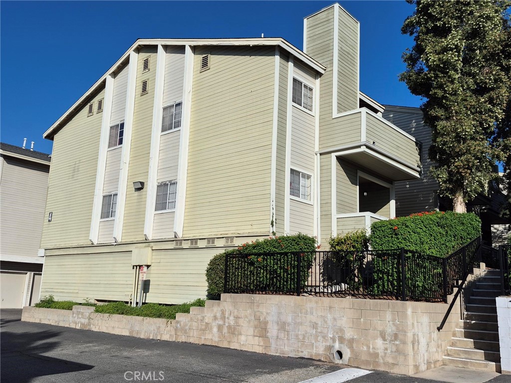 777 South Citrus Avenue, Unit 119 Azusa, CA 91702 - Photo 1 of 18 a front view of a house with garage