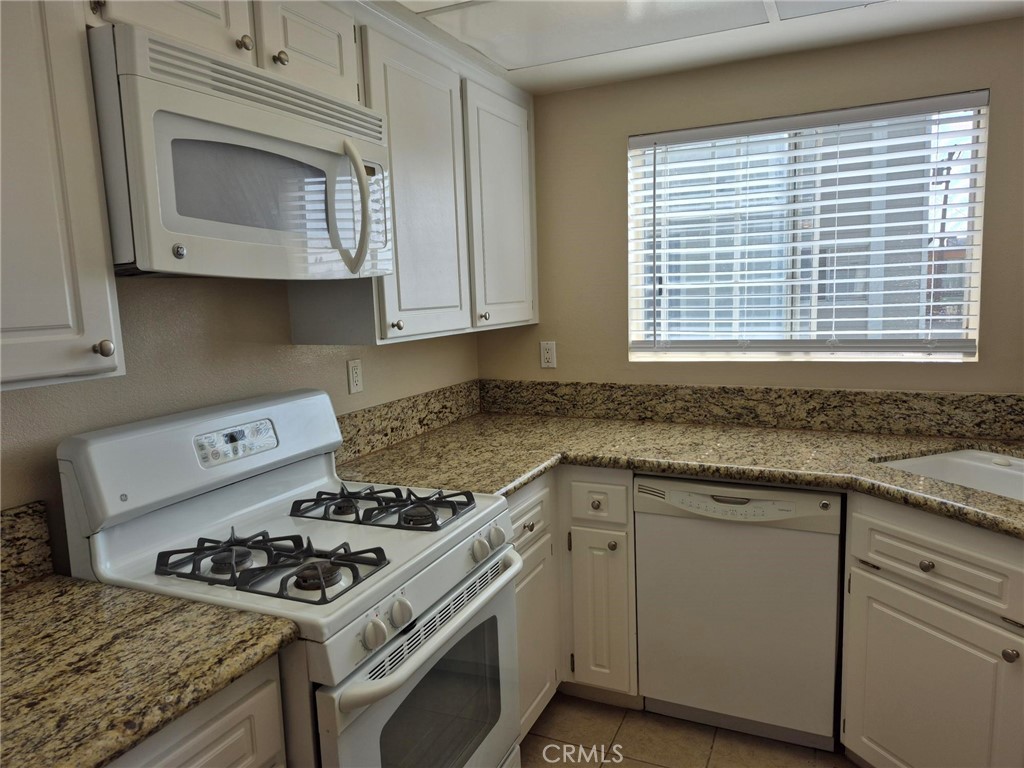 777 South Citrus Avenue, Unit 119 Azusa, CA 91702 - Photo 12 of 18 a kitchen with sink stove and cabinets
