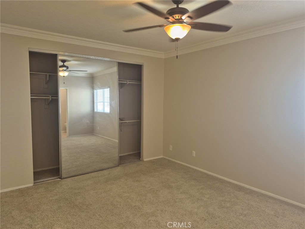 777 South Citrus Avenue, Unit 119 Azusa, CA 91702 - Photo 13 of 18 an empty room with a mirror and a fan