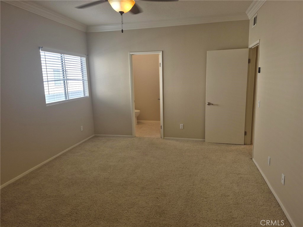 777 South Citrus Avenue, Unit 119 Azusa, CA 91702 - Photo 14 of 18 an empty room with a window and chandelier fan
