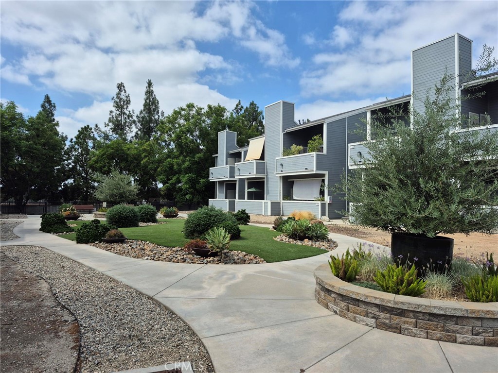 777 South Citrus Avenue, Unit 119 Azusa, CA 91702 - Photo 3 of 18 a front view of a house with a yard and potted plants