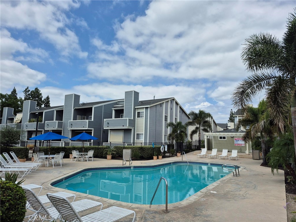 777 South Citrus Avenue, Unit 119 Azusa, CA 91702 - Photo 4 of 18 a view of a swimming pool with outdoor seating and a yard