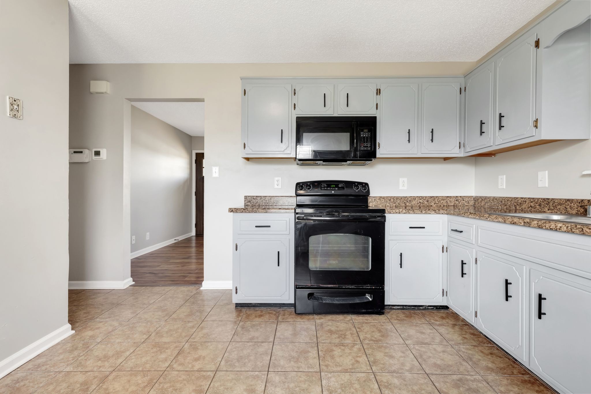 931 State Line Road Oak Grove, KY 42262 - Photo 12 of 24 a kitchen with a stove a sink and a refrigerator