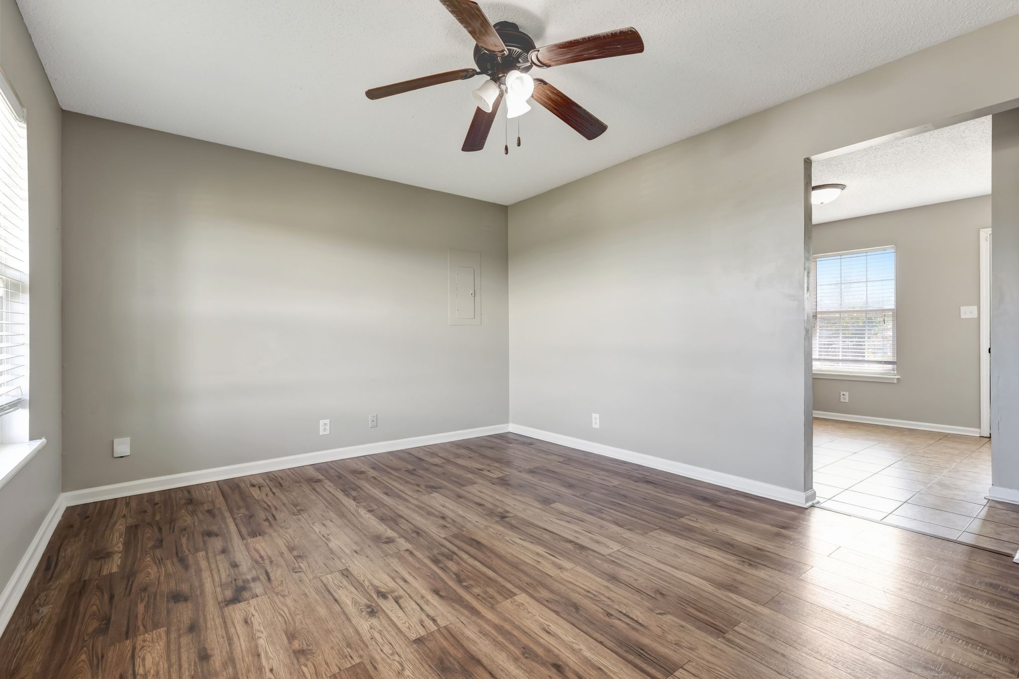 931 State Line Road Oak Grove, KY 42262 - Photo 6 of 24 an empty room with wooden floor chandelier fan and windows