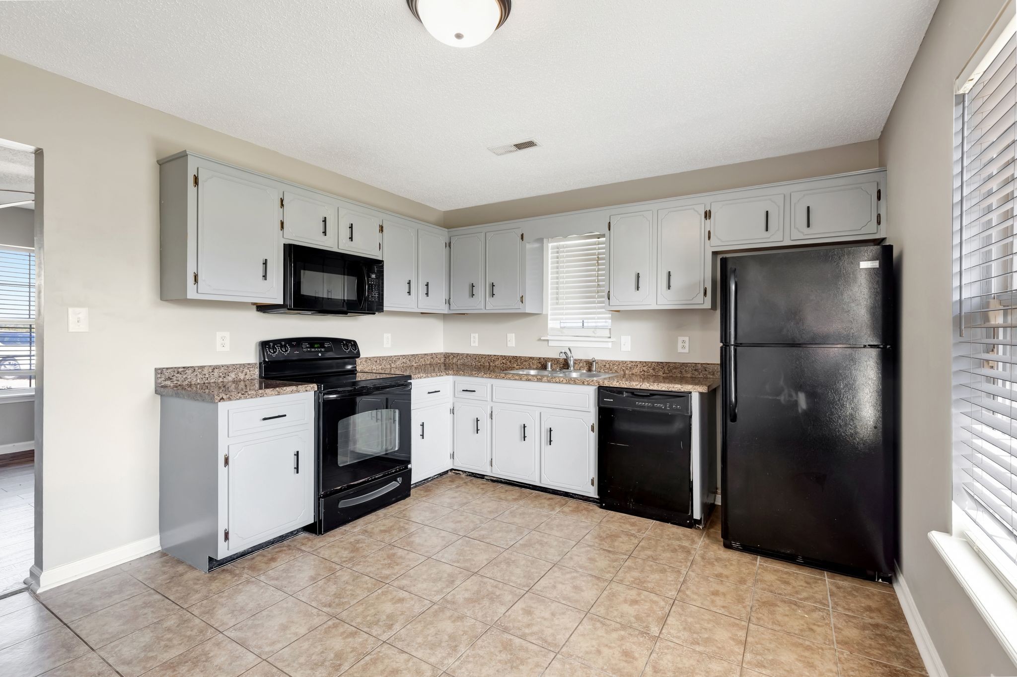 931 State Line Road Oak Grove, KY 42262 - Photo 9 of 24 a kitchen with a refrigerator stove and microwave