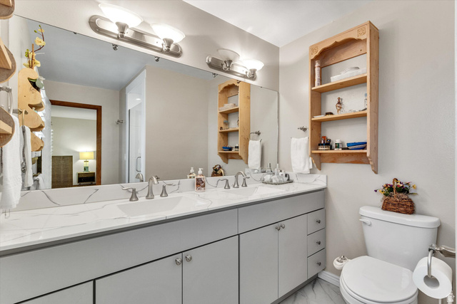 2863 Fallentine Road Sandy, UT 84093 - Photo 36 of 48 Spacious bathroom featuring a double vanity with a stone-finish countertop, light gray cabinetry, and dual undermount sinks