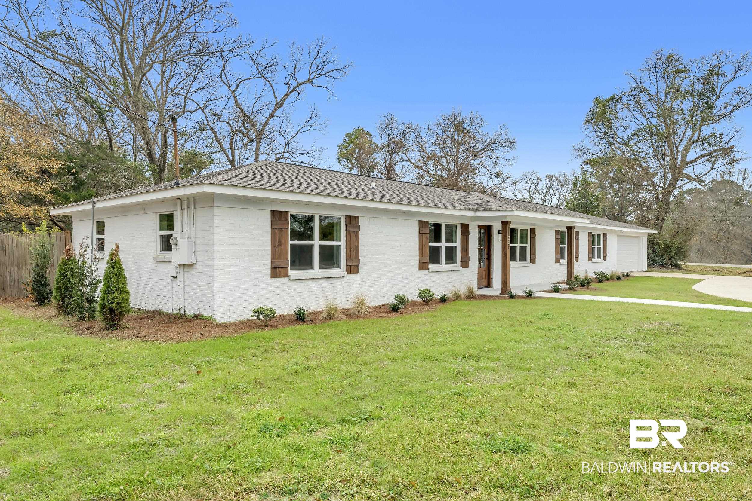 11381 Normandy Drive East Semmes, AL 36575 - Photo 2 of 23 Ranch-style home featuring a shingled roof, brick siding, an attached garage, and covered porch