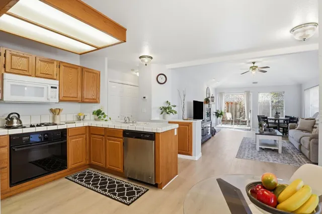 a kitchen with stainless steel appliances granite countertop a sink stove and cabinets