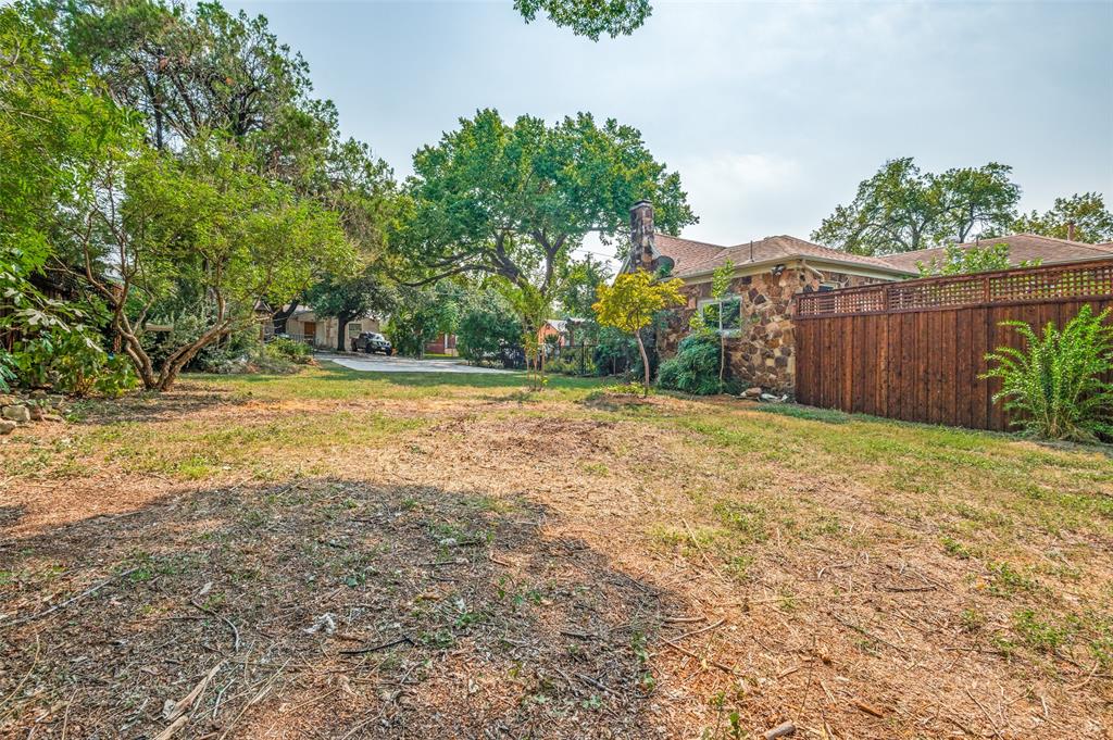 119 Archer Avenue Cockrell Hill, TX 75211 - Photo 2 of 8 a view of a yard with an tree