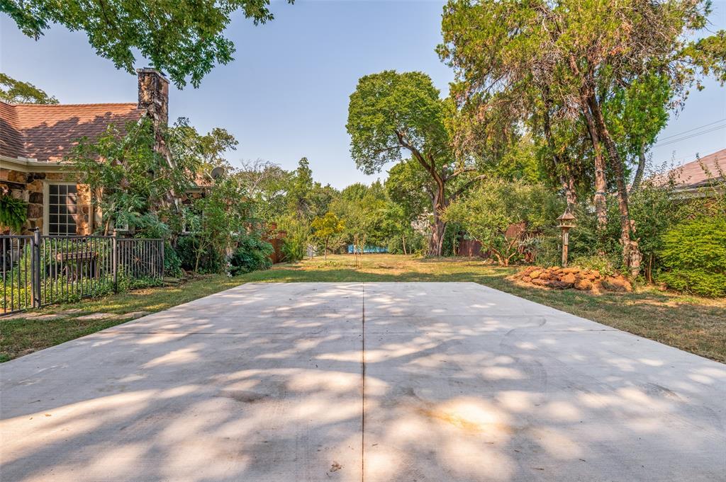 119 Archer Avenue Cockrell Hill, TX 75211 - Photo 3 of 8 a view of a yard with plants and large trees