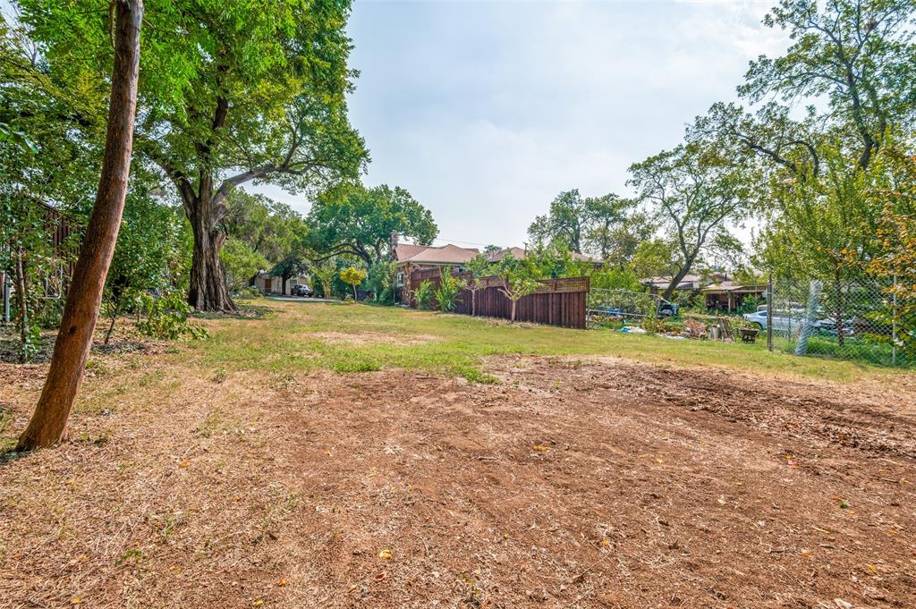 119 Archer Avenue Cockrell Hill, TX 75211 - Photo 7 of 8 a view of a field with trees in the background