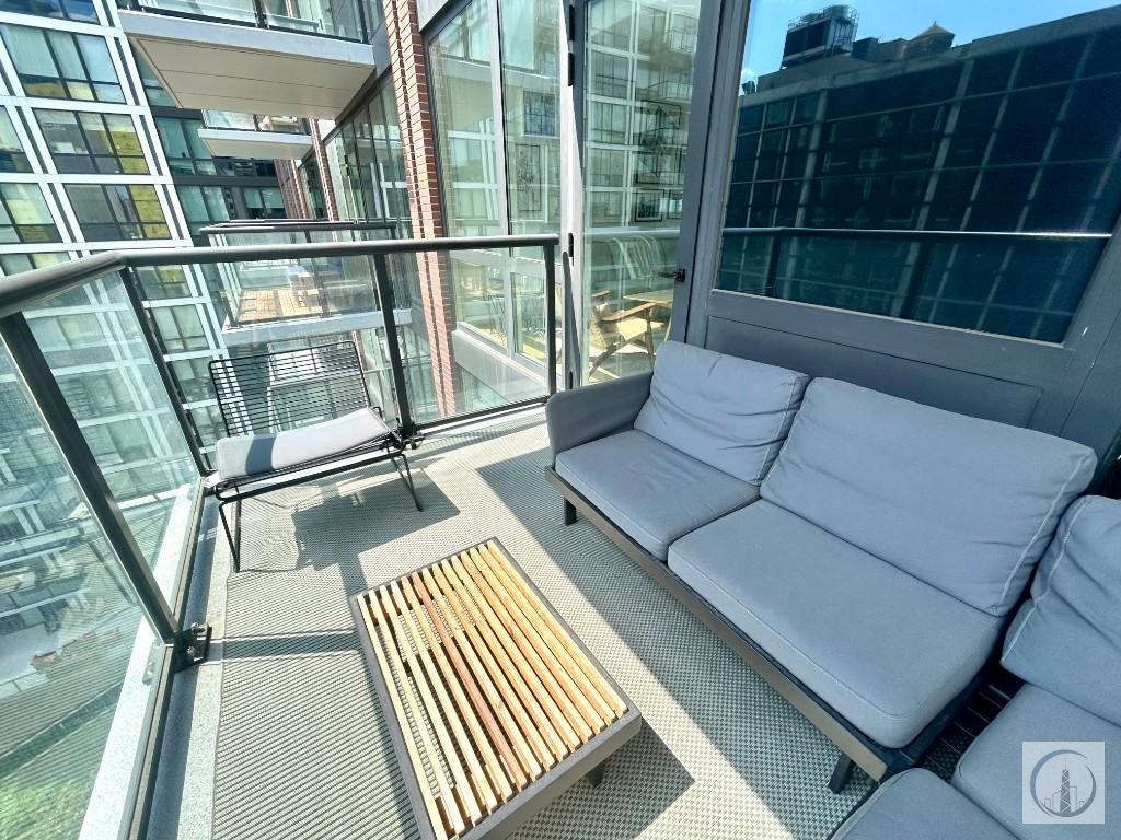 33 Bond Street, Unit 1029 Brooklyn, NY 11201 - Photo 1 of 1 a picture of a living room with a floor to ceiling window and wooden floor
