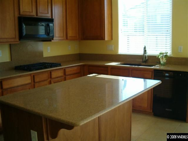 11230 Messina Way Reno, NV 89521 - Photo 7 of 9 a kitchen with a sink and a microwave