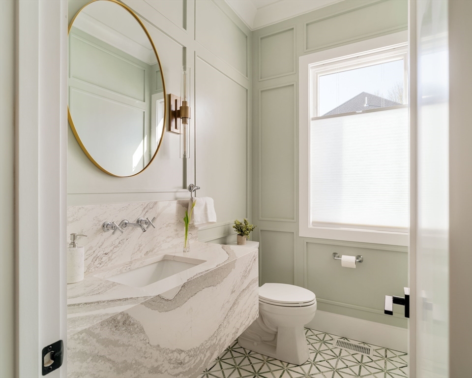 234 Valley Road Needham, MA 02492 - Photo 16 of 42 a bathroom with a toilet sink and mirror