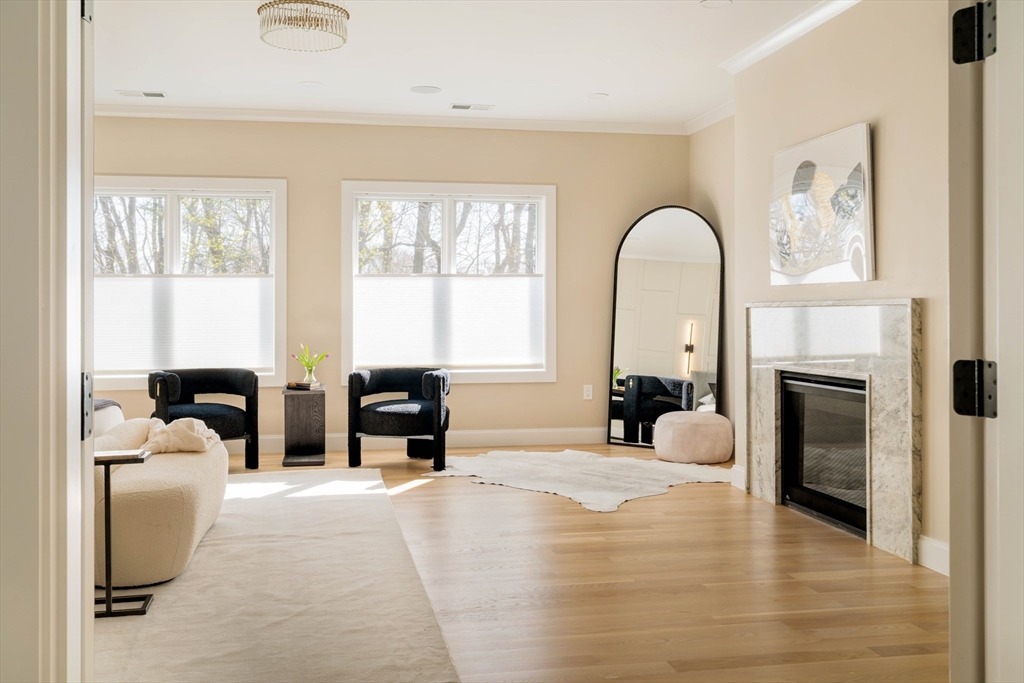 234 Valley Road Needham, MA 02492 - Photo 29 of 42 a large bedroom with a large bed and a fireplace