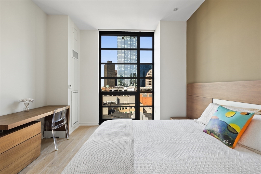 580 Washington Street, Unit PH5 Boston, MA 02111 - Photo 13 of 37 a bedroom with a bed and a window