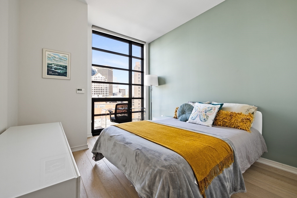 580 Washington Street, Unit PH5 Boston, MA 02111 - Photo 18 of 37 a bedroom with a bed and a closet