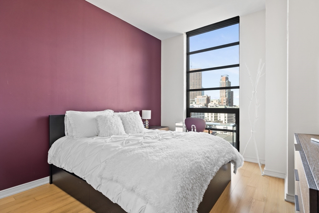 580 Washington Street, Unit PH5 Boston, MA 02111 - Photo 21 of 37 a bedroom with a bed and a window