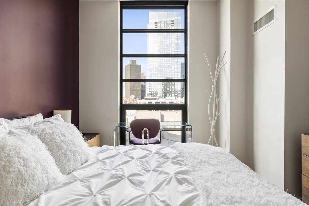 580 Washington Street, Unit PH5 Boston, MA 02111 - Photo 22 of 37 a bedroom with a bed and a window