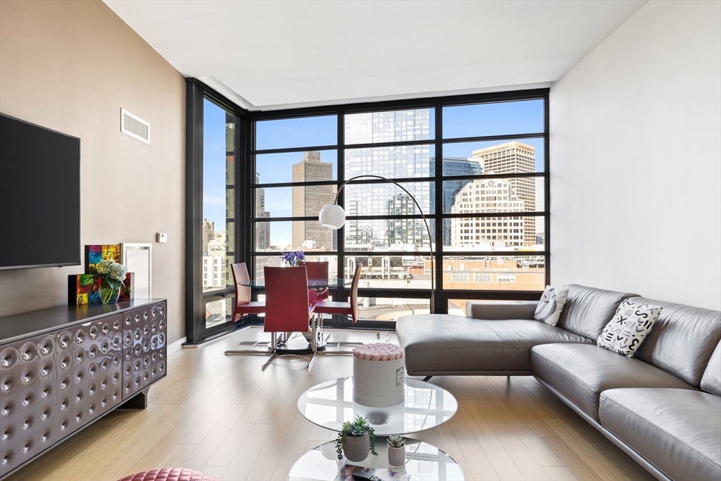 580 Washington Street, Unit PH5 Boston, MA 02111 - Photo 3 of 37 a living room with furniture and a large window