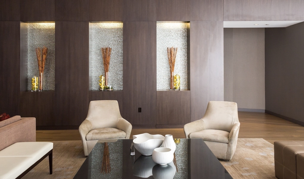 580 Washington Street, Unit PH5 Boston, MA 02111 - Photo 31 of 37 a living room with furniture and a window