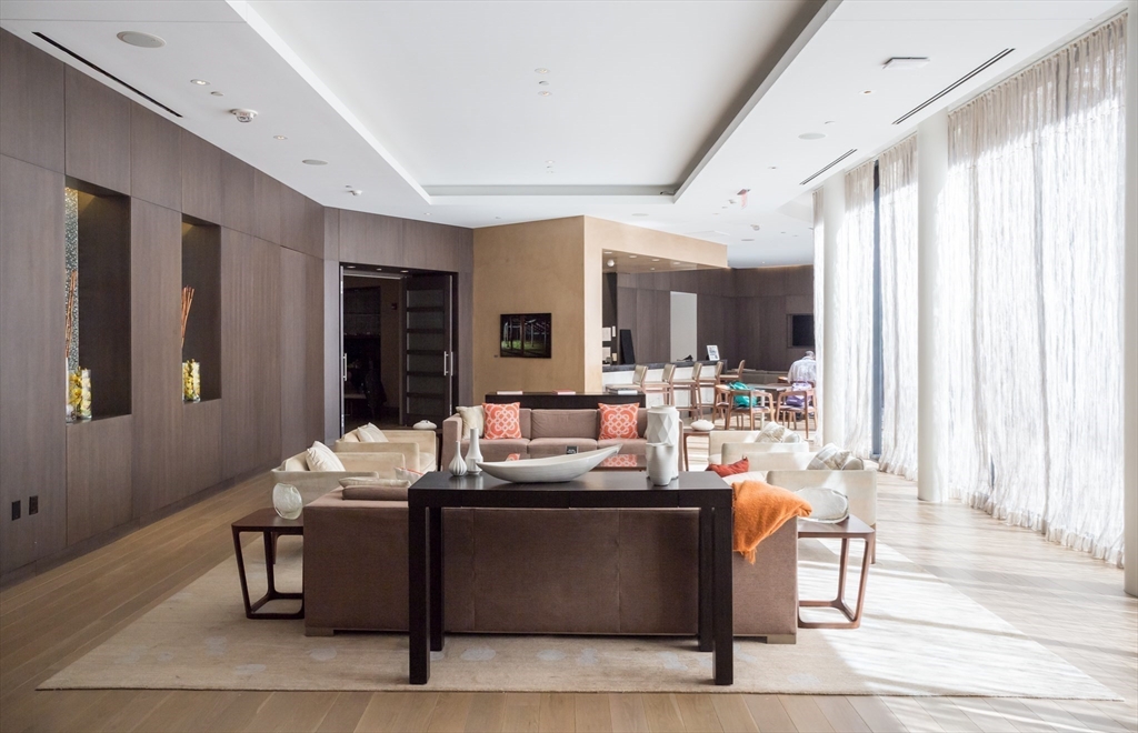 580 Washington Street, Unit PH5 Boston, MA 02111 - Photo 32 of 37 a room with a table chairs and a living room view