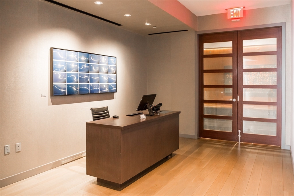 580 Washington Street, Unit PH5 Boston, MA 02111 - Photo 37 of 37 a workspace with furniture and window