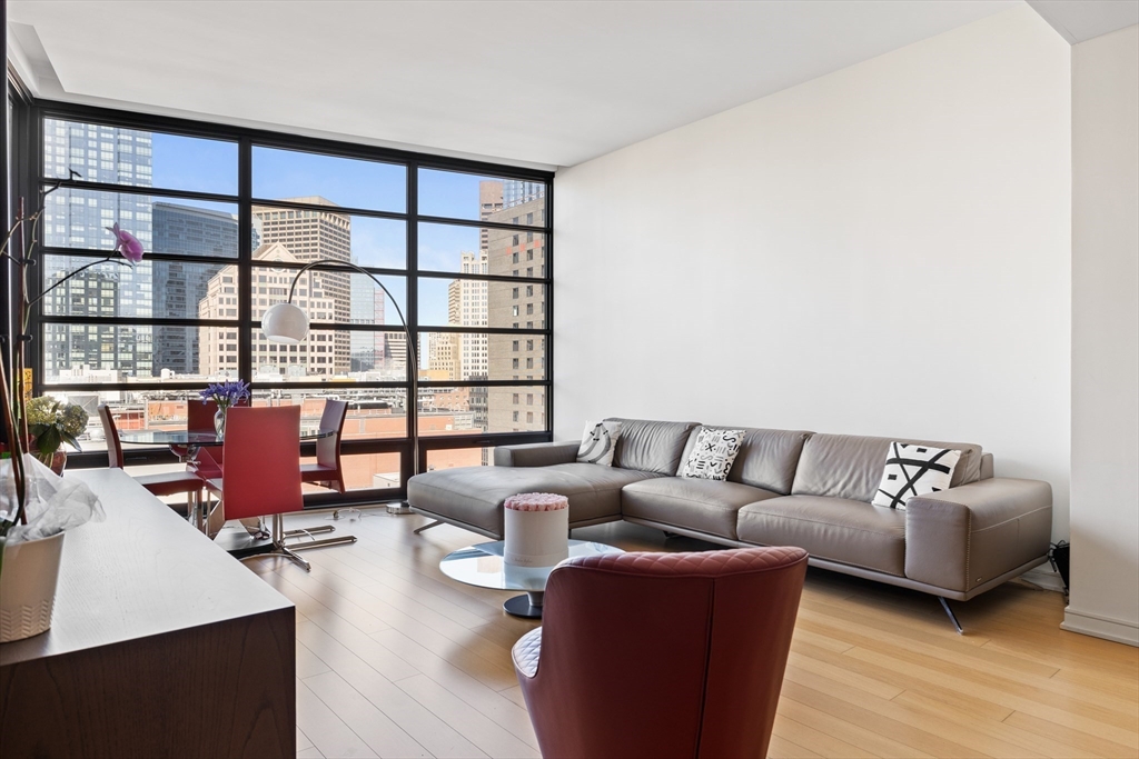 580 Washington Street, Unit PH5 Boston, MA 02111 - Photo 4 of 37 a living room with furniture and a floor to ceiling window