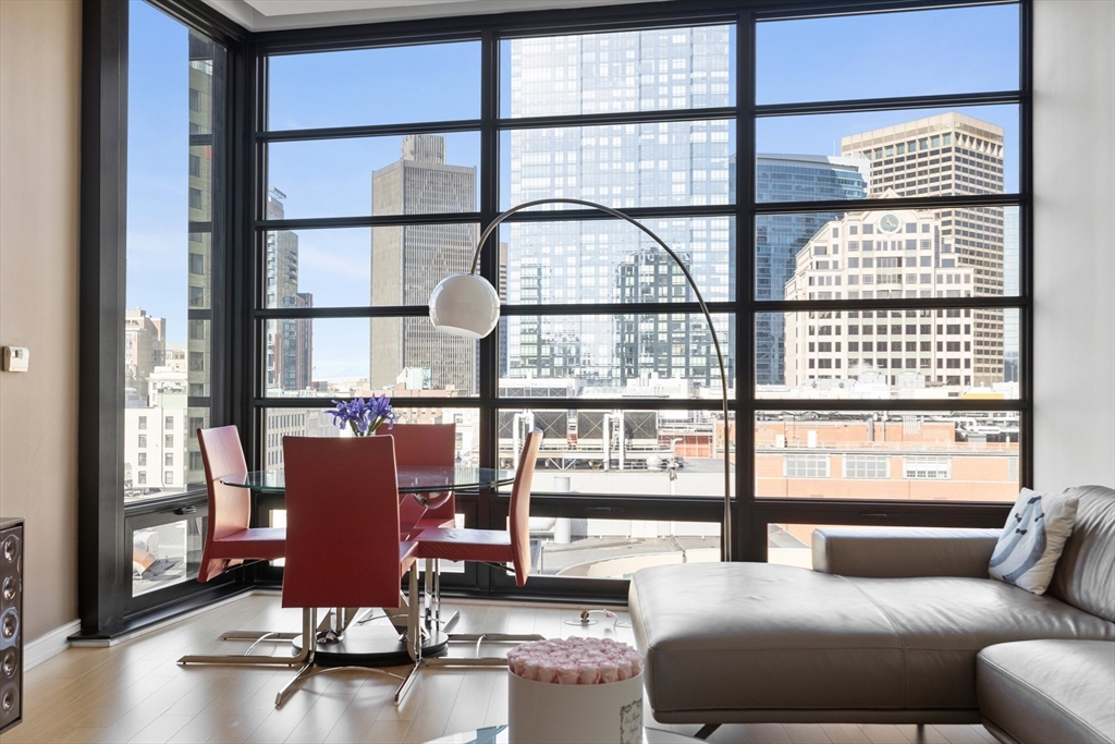 580 Washington Street, Unit PH5 Boston, MA 02111 - Photo 6 of 37 a living room with furniture and floor to ceiling windows