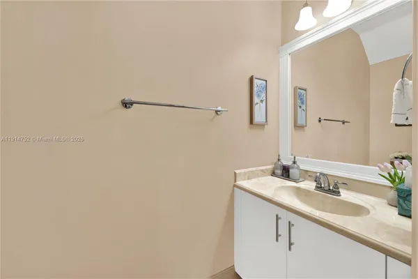 a white toilet sitting next to a bathroom sink